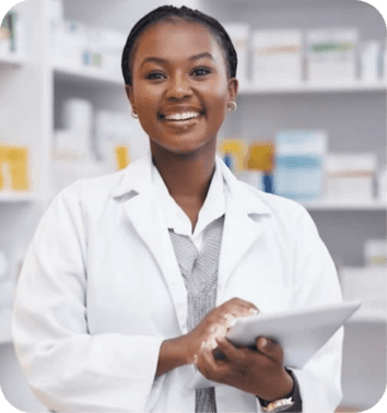 A smiling female pharmacist in a clean, modern pharmacy, holding a digital tablet.
